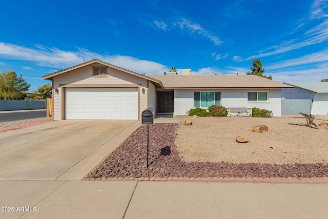 ranch-style house with concrete driveway and an attached garage