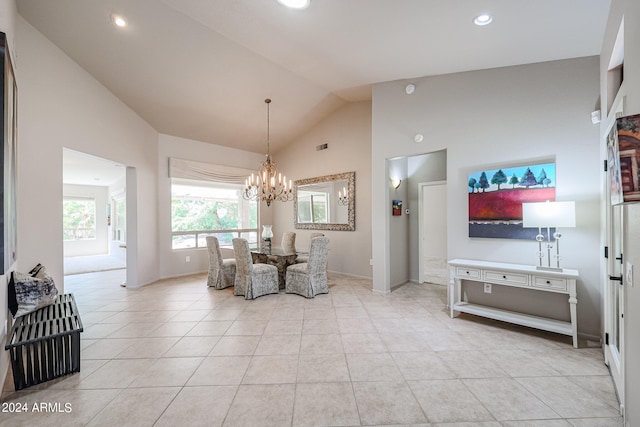 dining room featuring an inviting chandelier, high vaulted ceiling, and light tile patterned floors