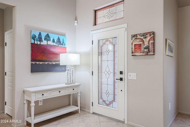 foyer entrance with light tile patterned floors