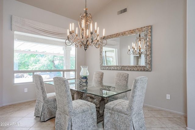 tiled dining room featuring lofted ceiling