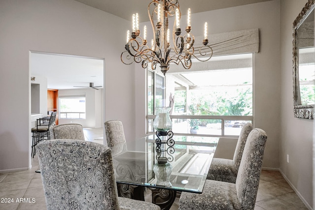 tiled dining area featuring ceiling fan with notable chandelier