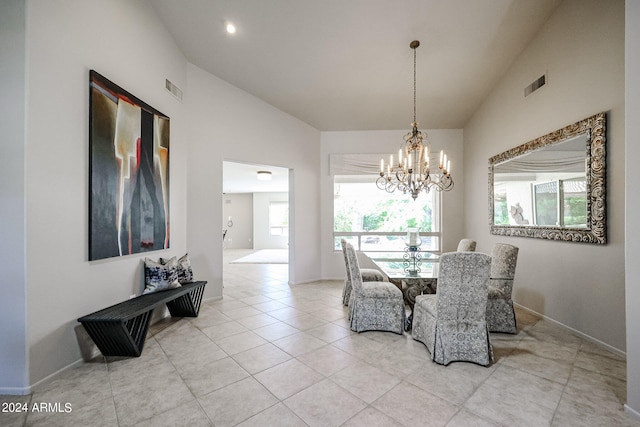 dining room with light tile patterned floors, vaulted ceiling, and a notable chandelier