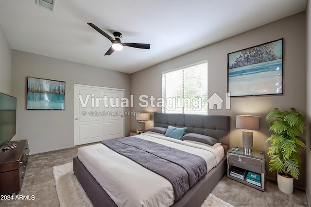 bedroom with ceiling fan and light colored carpet