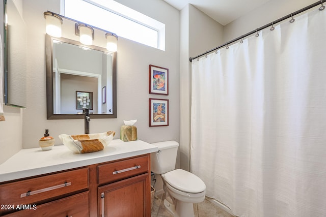 bathroom featuring toilet and vanity