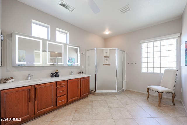 bathroom featuring an enclosed shower, vanity, ceiling fan, and a healthy amount of sunlight