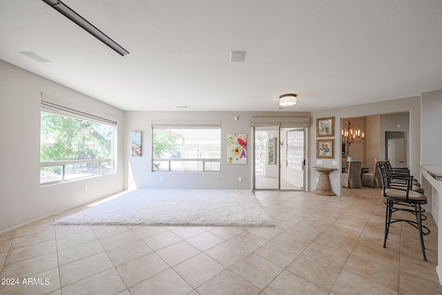 interior space with an inviting chandelier and light tile patterned floors