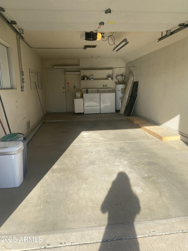 garage with electric water heater, washer and clothes dryer, and a garage door opener