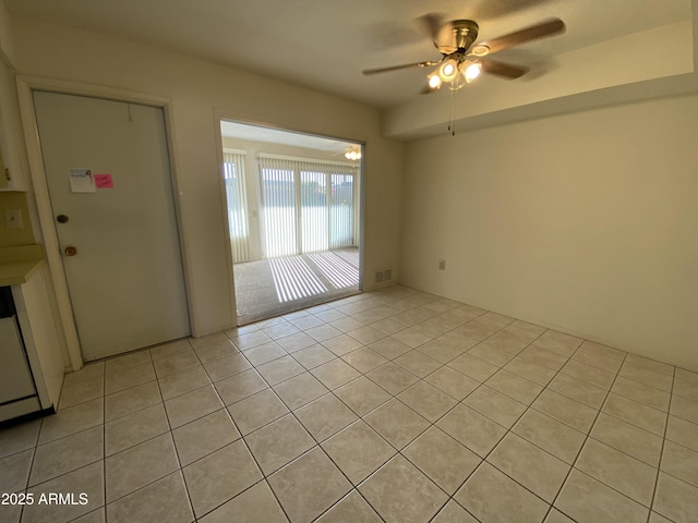 tiled empty room with ceiling fan