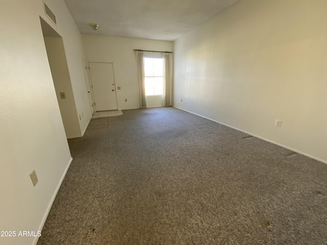 unfurnished room with dark carpet