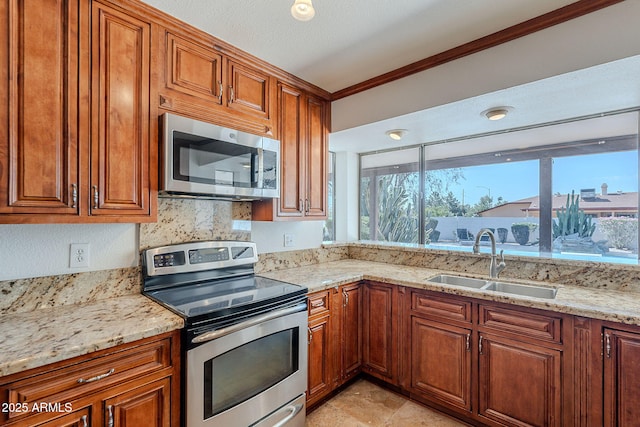5539 E Dahlia Dr, Scottsdale, AZ 85254 - kitchen with stainless steel appliances, a sink, brown cabinetry, and ornamental molding