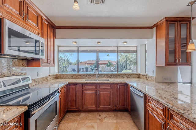 5539 E Dahlia Dr, Scottsdale, AZ 85254 - kitchen with appliances with stainless steel finishes, a sink, plenty of natural light, light stone counters, and a textured ceiling