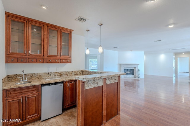 5539 E Dahlia Dr, Scottsdale, AZ 85254 - kitchen featuring fridge, a sink, light stone counters, and brown cabinets
