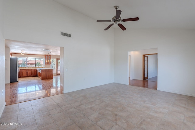 5539 E Dahlia Dr, Scottsdale, AZ 85254 - spare room with ceiling fan, high vaulted ceiling, baseboards, and light tile patterned floors