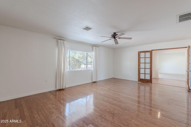 5539 E Dahlia Dr, Scottsdale, AZ 85254 - empty room with a ceiling fan, wood finished floors, and baseboards
