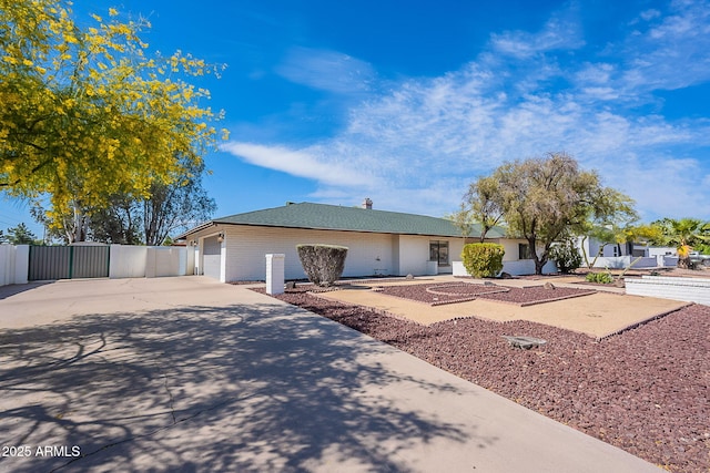 5539 E Dahlia Dr, Scottsdale, AZ 85254 - ranch-style house featuring concrete driveway, brick siding, a garage, and a chimney