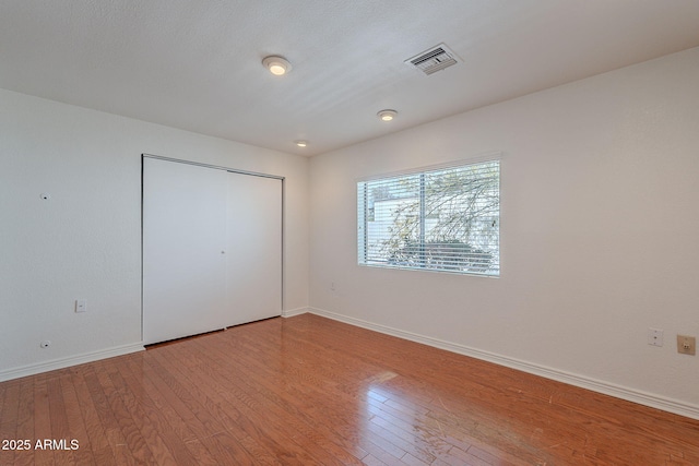 5539 E Dahlia Dr, Scottsdale, AZ 85254 - unfurnished bedroom featuring light wood-type flooring, baseboards, and a closet