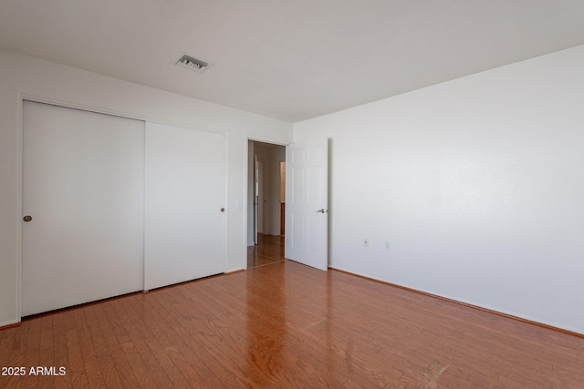 5539 E Dahlia Dr, Scottsdale, AZ 85254 - unfurnished bedroom with wood finished floors and a closet