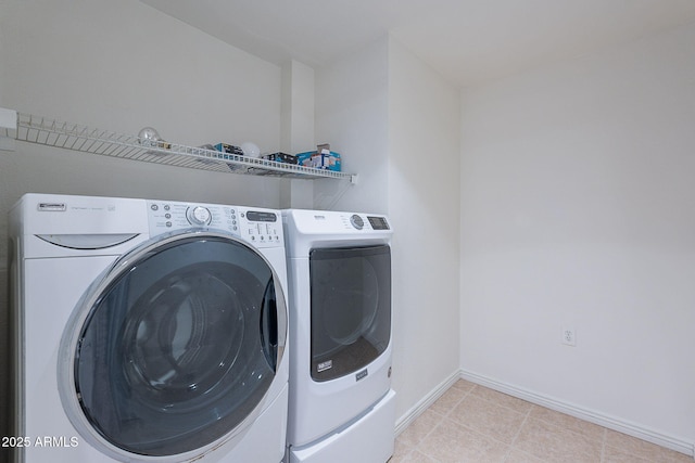 5539 E Dahlia Dr, Scottsdale, AZ 85254 - laundry room featuring washer and clothes dryer, baseboards, and light tile patterned floors