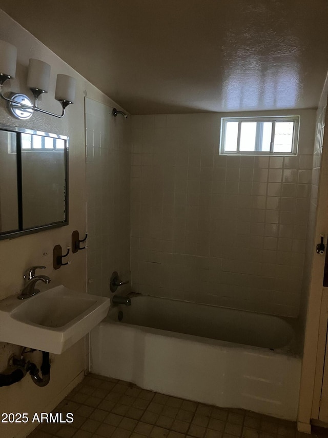 bathroom with tiled shower / bath, tile patterned flooring, and sink