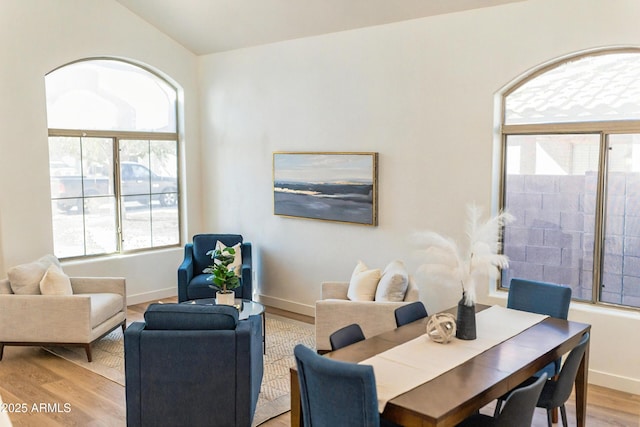 dining area with light wood-style flooring and baseboards