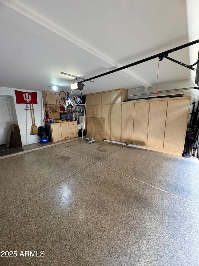 135 S Abalone Dr, Gilbert, AZ 85233 - garage featuring a garage door opener and a workshop area