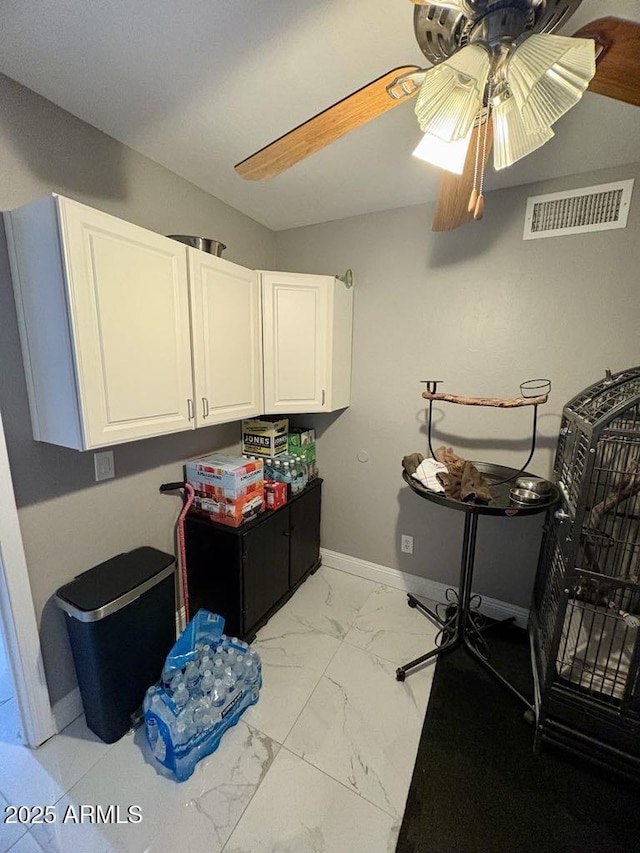 135 S Abalone Dr, Gilbert, AZ 85233 - laundry area featuring light marble finish flooring, baseboards, and ceiling fan