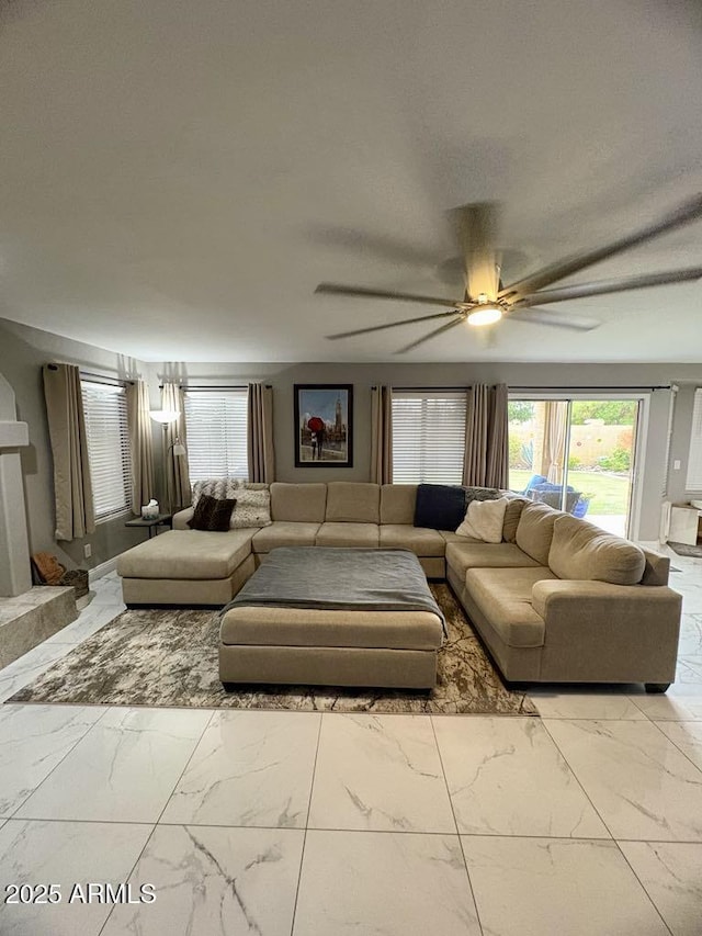 135 S Abalone Dr, Gilbert, AZ 85233 - living area featuring marble look tile flooring and a ceiling fan