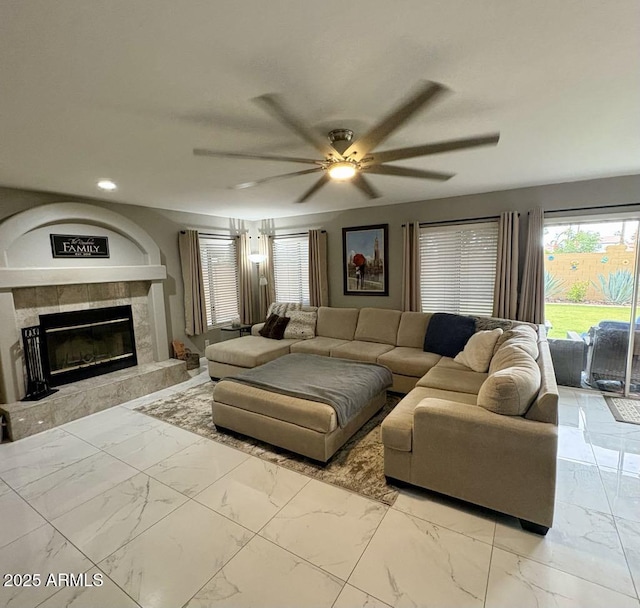 135 S Abalone Dr, Gilbert, AZ 85233 - living room featuring marble look tile flooring, a ceiling fan, a fireplace, and recessed lighting