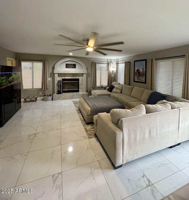 135 S Abalone Dr, Gilbert, AZ 85233 - living room featuring marble look tile flooring, a ceiling fan, a tiled fireplace, and recessed lighting