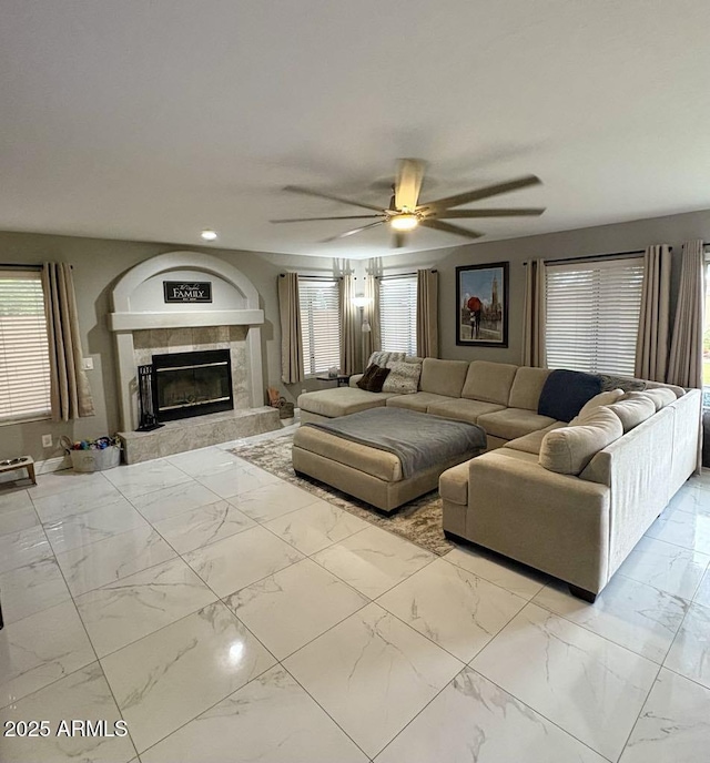 135 S Abalone Dr, Gilbert, AZ 85233 - living room with marble finish flooring, a ceiling fan, healthy amount of natural light, a tiled fireplace, and recessed lighting