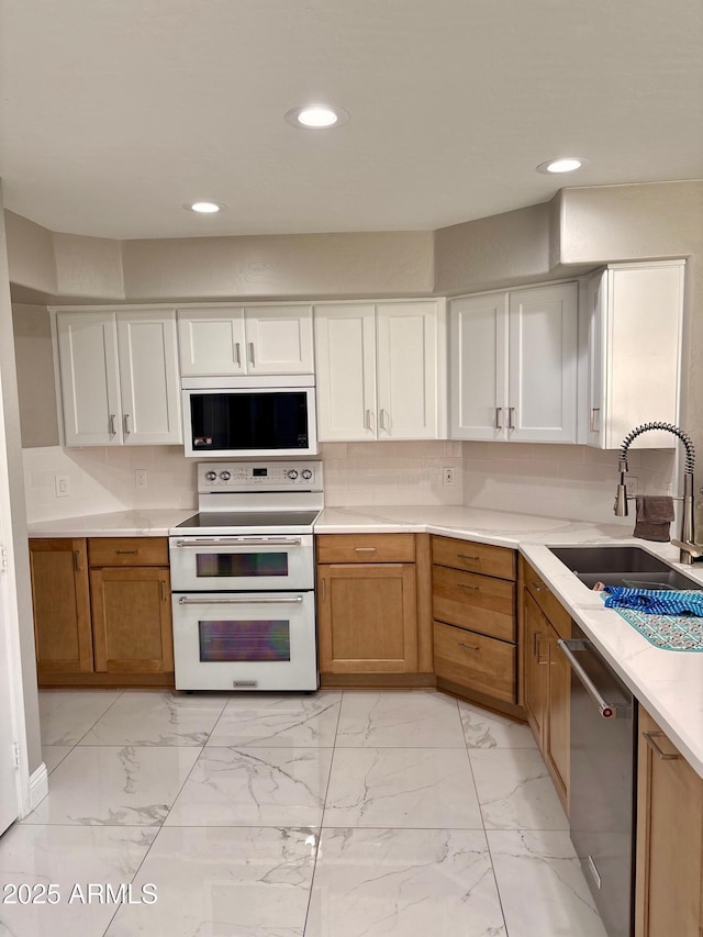 135 S Abalone Dr, Gilbert, AZ 85233 - kitchen featuring white appliances, a sink, light marble finish flooring, light countertops, and recessed lighting
