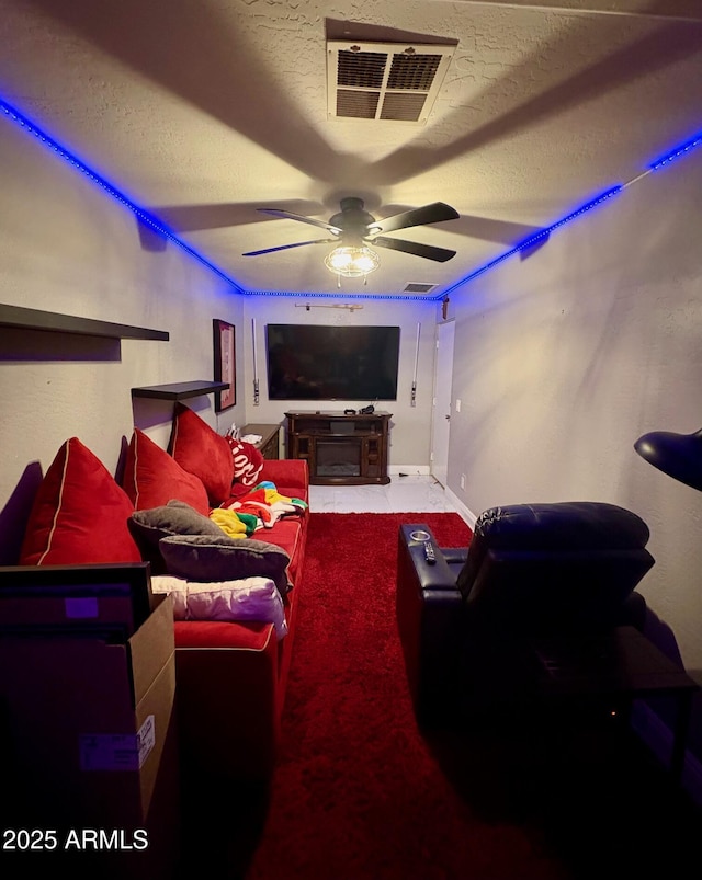 135 S Abalone Dr, Gilbert, AZ 85233 - cinema room featuring a ceiling fan, a textured ceiling, and baseboards