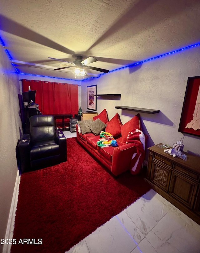 135 S Abalone Dr, Gilbert, AZ 85233 - home theater room featuring a ceiling fan, marble look tile flooring, and a textured ceiling