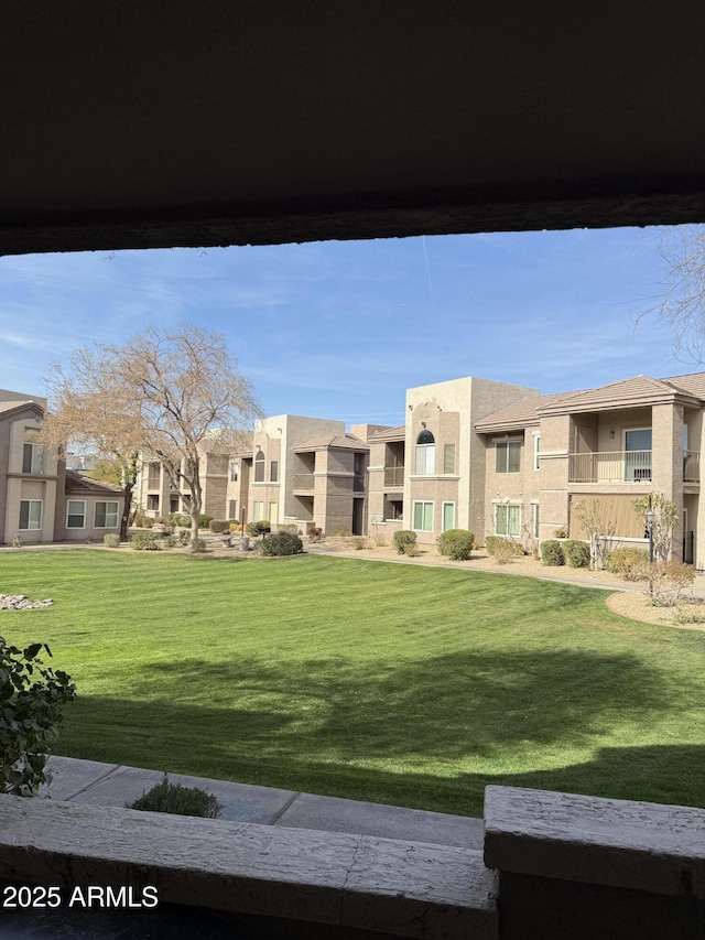 surrounding community featuring a residential view and a yard