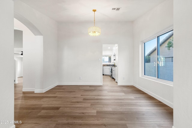 3037 E Bighorn Ave, Phoenix, AZ 85048 - interior space featuring arched walkways, visible vents, wood finished floors, a chandelier, and baseboards