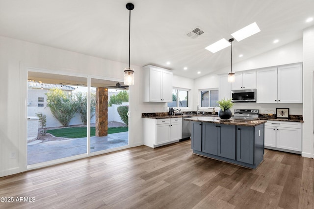 3037 E Bighorn Ave, Phoenix, AZ 85048 - kitchen with visible vents, appliances with stainless steel finishes, a center island, decorative light fixtures, and white cabinetry