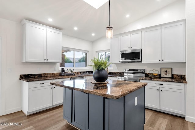 3037 E Bighorn Ave, Phoenix, AZ 85048 - kitchen featuring stainless steel appliances, dark stone countertops, decorative light fixtures, and white cabinets