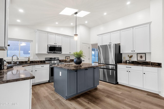 3037 E Bighorn Ave, Phoenix, AZ 85048 - kitchen with pendant lighting, stainless steel appliances, a kitchen island, and white cabinets