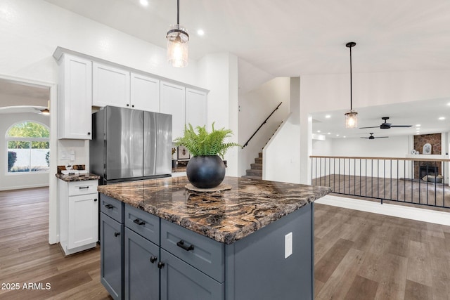 3037 E Bighorn Ave, Phoenix, AZ 85048 - kitchen featuring freestanding refrigerator, dark wood-style flooring, white cabinetry, and pendant lighting