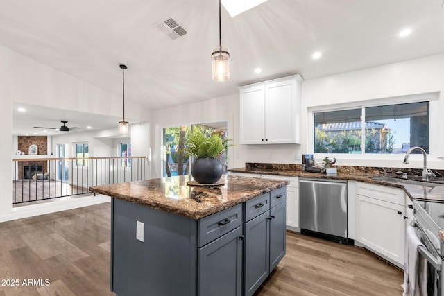 3037 E Bighorn Ave, Phoenix, AZ 85048 - kitchen with visible vents, appliances with stainless steel finishes, white cabinets, a kitchen island, and a sink