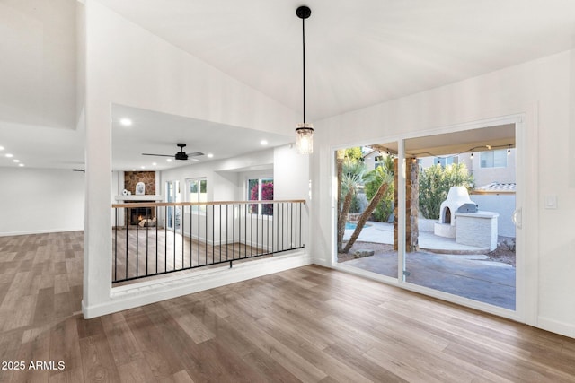 3037 E Bighorn Ave, Phoenix, AZ 85048 - spare room with baseboards, wood finished floors, vaulted ceiling, a fireplace, and recessed lighting