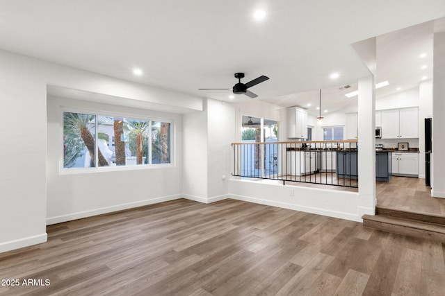 3037 E Bighorn Ave, Phoenix, AZ 85048 - spare room with recessed lighting, a ceiling fan, baseboards, vaulted ceiling, and light wood finished floors