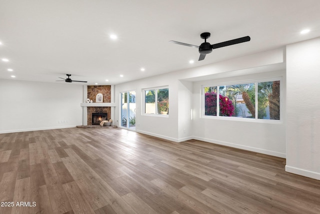 3037 E Bighorn Ave, Phoenix, AZ 85048 - unfurnished living room featuring recessed lighting, a stone fireplace, and wood finished floors