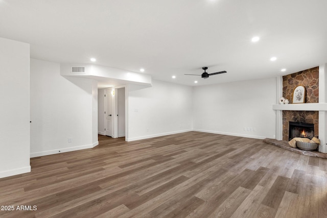 3037 E Bighorn Ave, Phoenix, AZ 85048 - unfurnished living room featuring baseboards, visible vents, wood finished floors, a fireplace, and recessed lighting