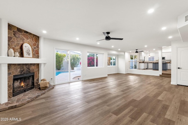 3037 E Bighorn Ave, Phoenix, AZ 85048 - unfurnished living room with a fireplace, wood finished floors, and recessed lighting