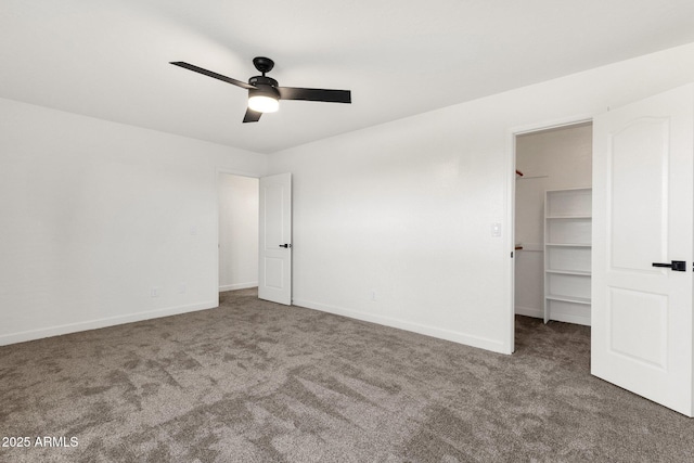 3037 E Bighorn Ave, Phoenix, AZ 85048 - unfurnished bedroom featuring baseboards, ceiling fan, a walk in closet, dark colored carpet, and a closet