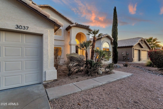 3037 E Bighorn Ave, Phoenix, AZ 85048 - view of front facade with a garage, a tile roof, and stucco siding