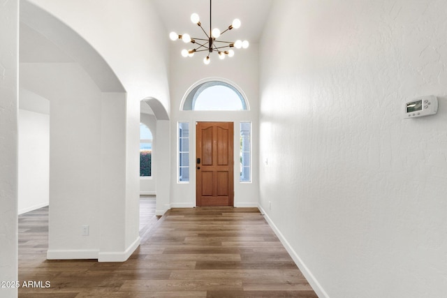 3037 E Bighorn Ave, Phoenix, AZ 85048 - entrance foyer with dark wood-style floors, arched walkways, a towering ceiling, and baseboards