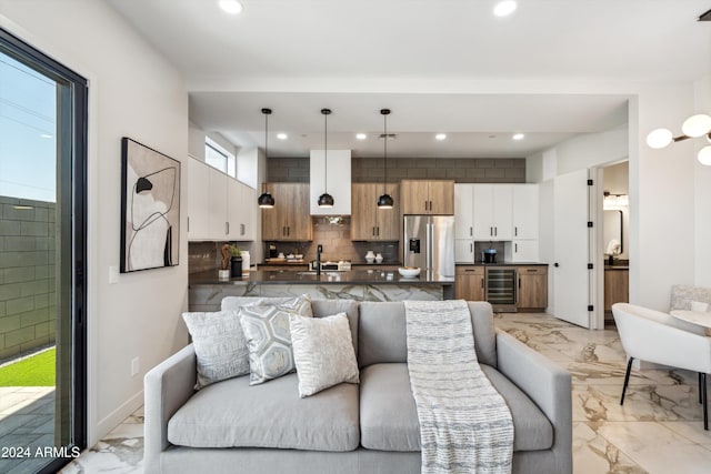 living room featuring marble finish floor, wine cooler, baseboards, and recessed lighting