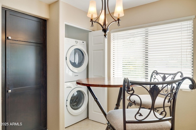 9555 E Raintree Dr E Unit 2061, Scottsdale, AZ 85260 - laundry area with stacked washer and clothes dryer, an inviting chandelier, laundry area, and light tile patterned floors